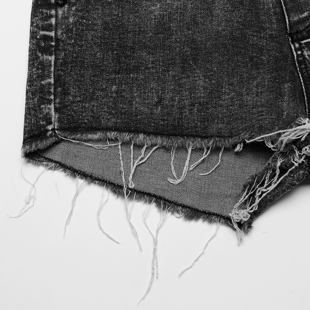 Close-up view of stylish high-waisted denim shorts featuring frayed hem and lace trim details.