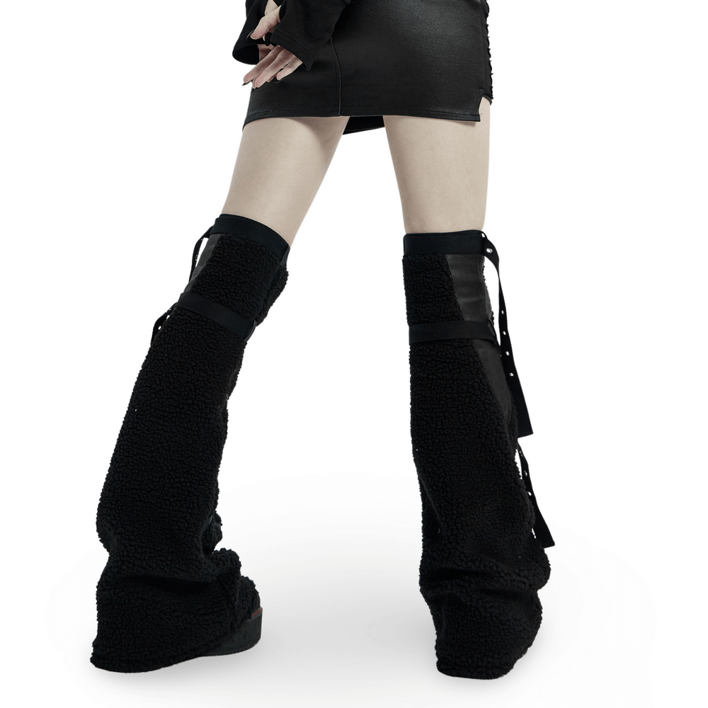 Edgy women's punk leg warmers with structured rubber front and soft black material, perfect for a bold style.