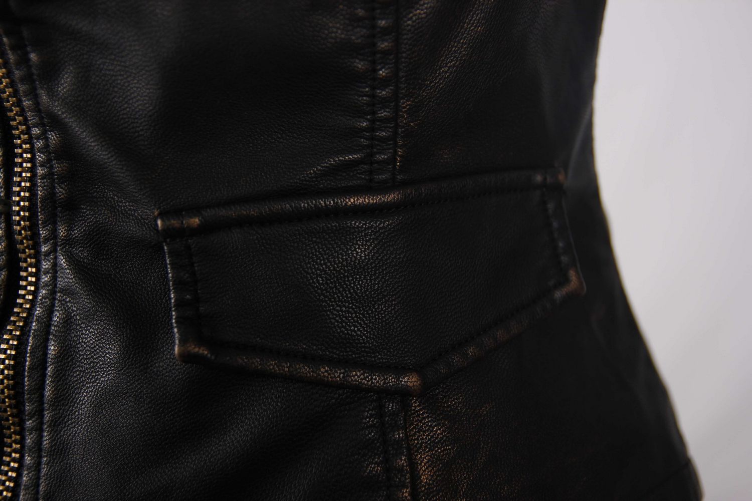 Close-up of the stylish black PU leather waistcoat showing the detailed stitching and pocket design.