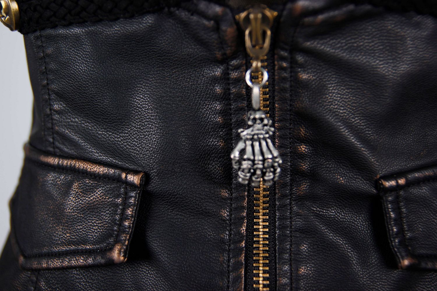 Close-up of stylish women's steampunk PU leather waistcoat featuring detailed zippers and decorative pockets.