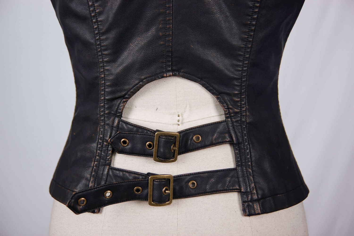 Back view of stylish women's steampunk PU leather waistcoat featuring golden buttons and adjustable buckles.