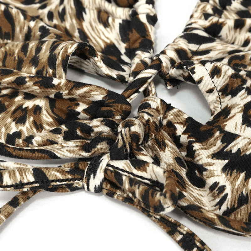 Close-up of stylish leopard print woman’s two-piece swimsuit with laces, showcasing chic design details.