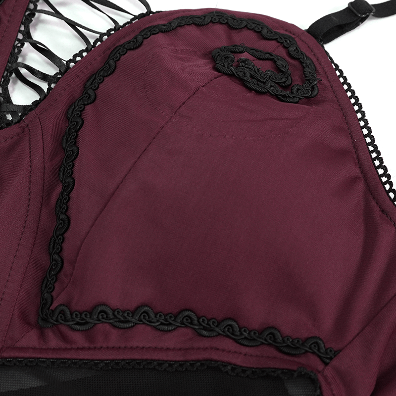 Close-up of stylish wine red one-piece swimsuit featuring intricate lace trim and gothic design elements.