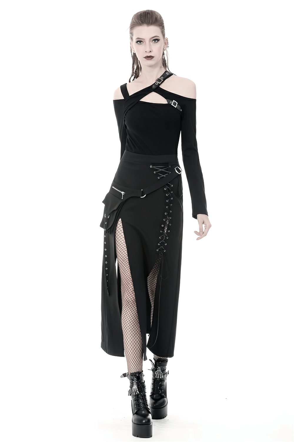 Model in stylish black gothic lace-up skirt with eyelets and pockets, paired with edgy crop top and chunky boots.