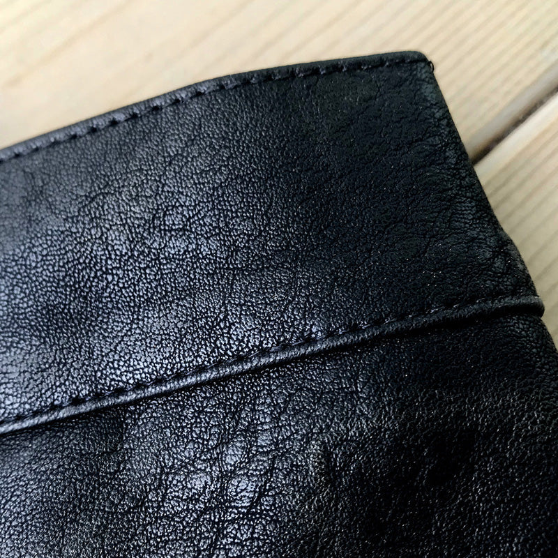 Close-up of black imitation leather fabric showcasing the texture and detail of women's high waist shorts.