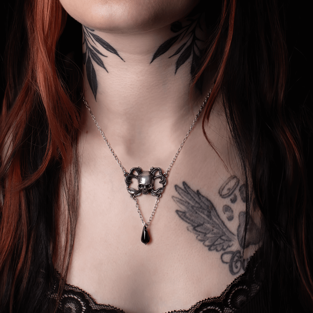 Gothic Sweet Death Skull Pendant with jet black crystal drop, displayed elegantly on a model's neck.