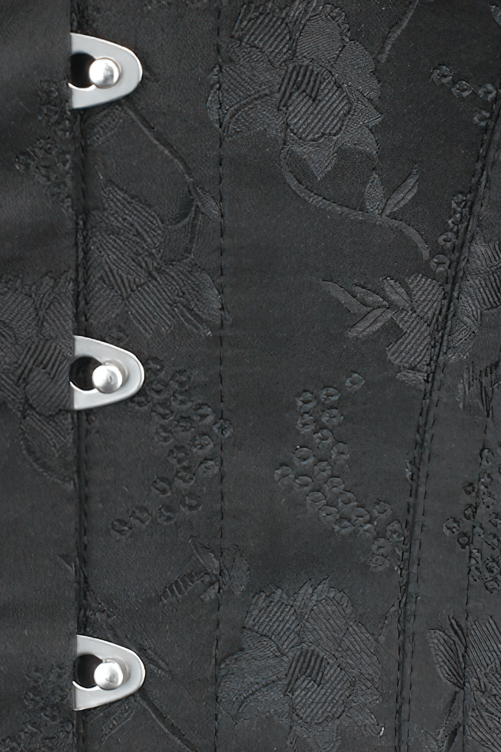 Close-up of Gothic floral overbust corset showcasing steel boning, black floral brocade, and silver eyelet details.