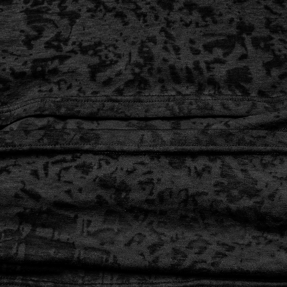 Close-up of black fabric with intricate texture, showcasing the unique design of a cropped hoodie.