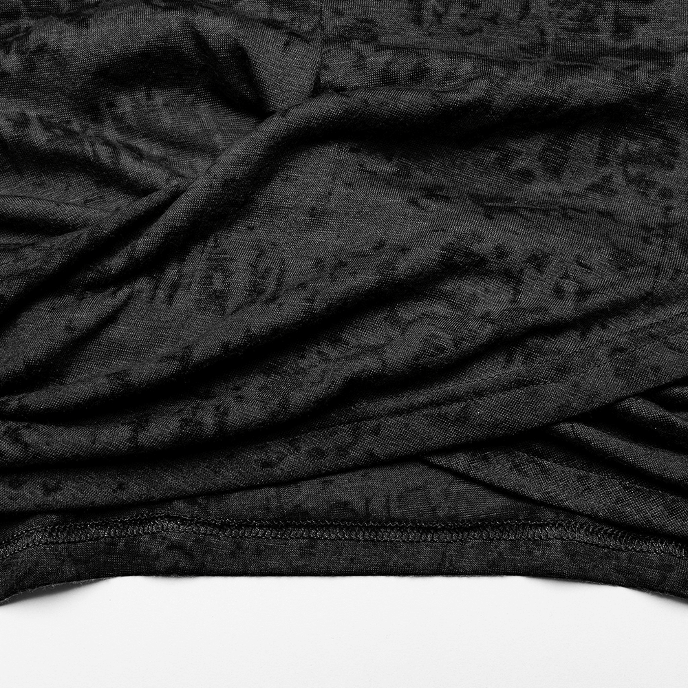 Close-up of black, textured fabric showcasing the criss-cross hem of a cropped hooded top.