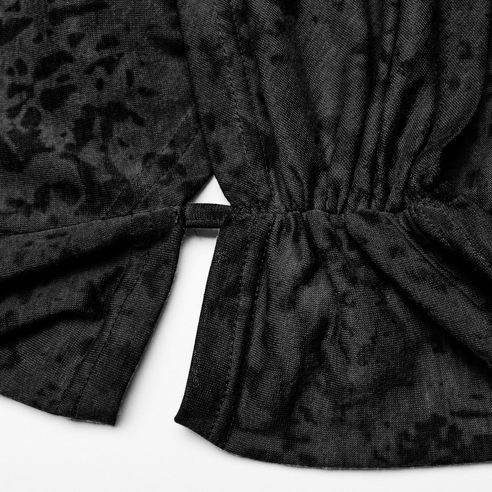 Close-up of the criss-cross hem detail on a black cropped hoodie, showcasing the unique fabric texture and design.