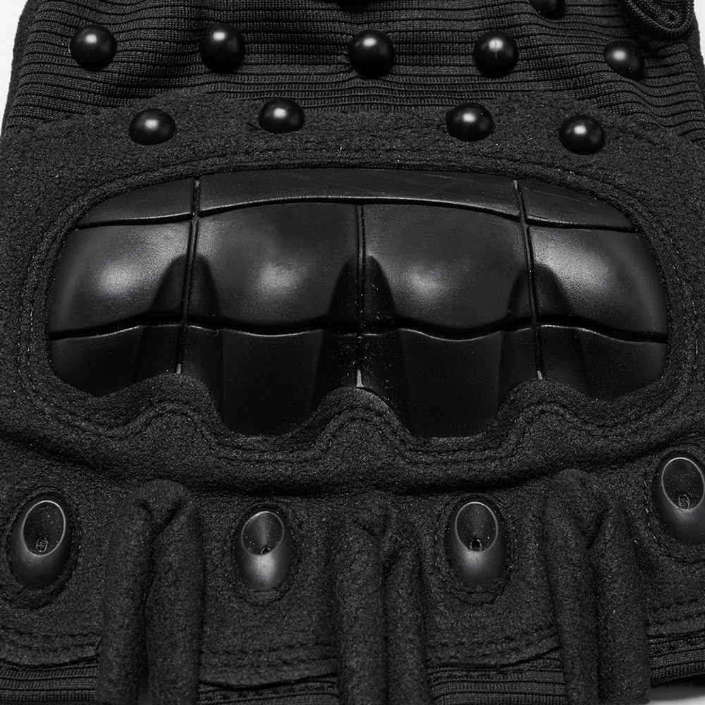 Close-up of tactical cyberpunk gloves featuring studded design and protective armor pads.