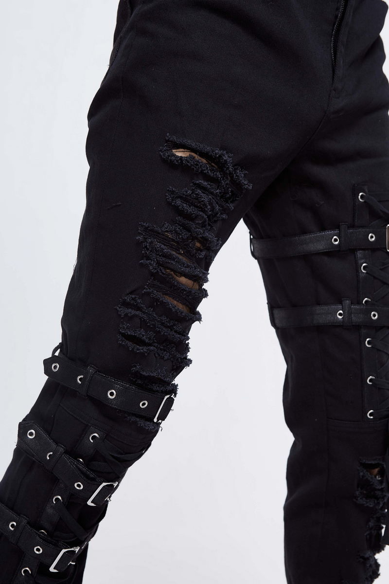 Gothic black skinny jeans with lace holes and straps, steampunk style men's pants with torn inserts, perfect for alternative fashion.