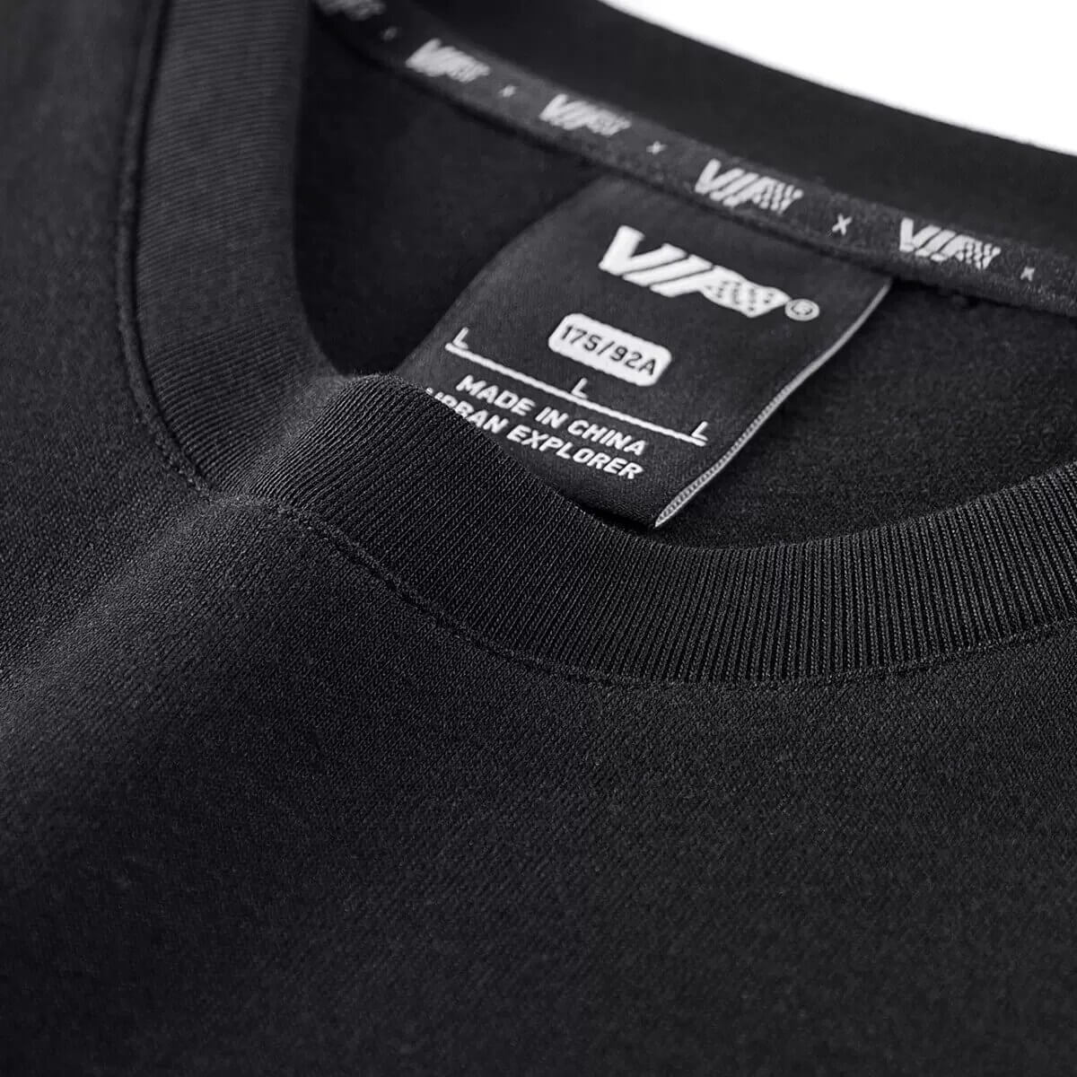 Close-up of the black tactical O-neck t-shirt neckline and label, showcasing quality craftsmanship and style.