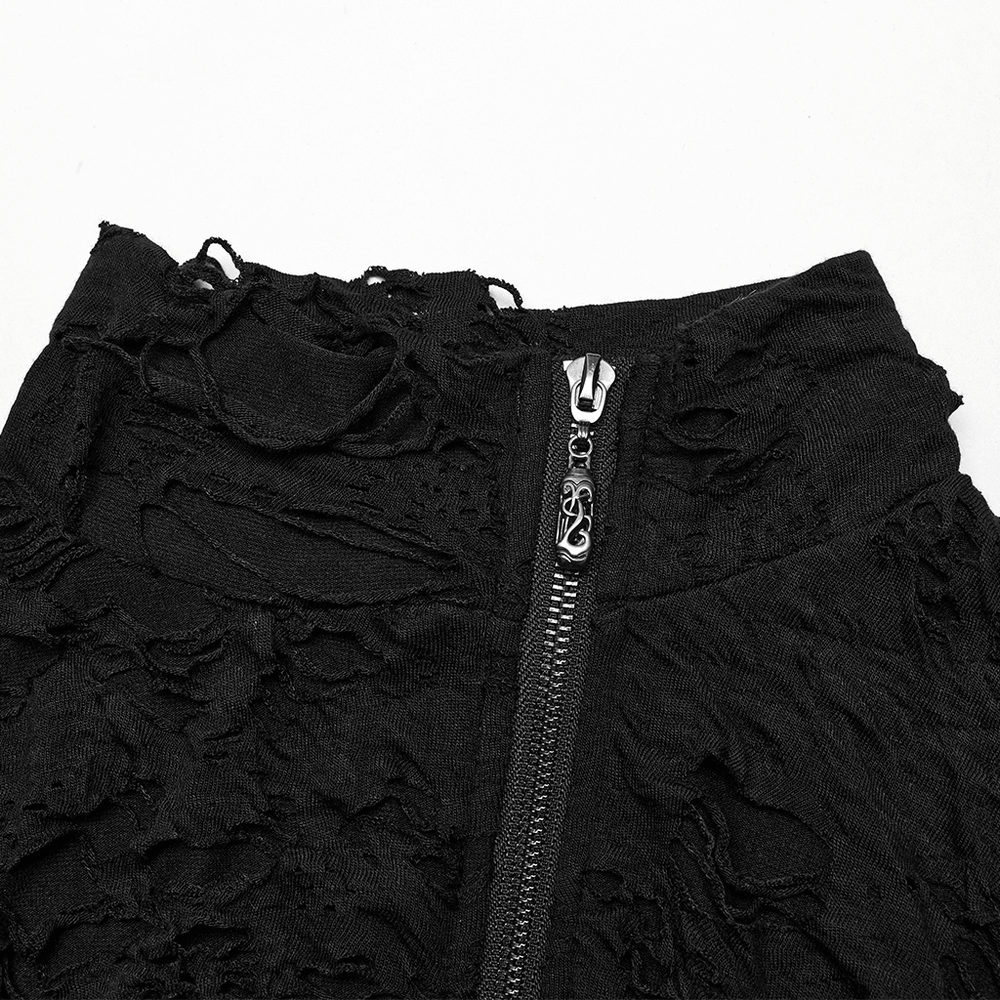 Close-up of a black tattered punk top featuring a front zipper and distressed texture.