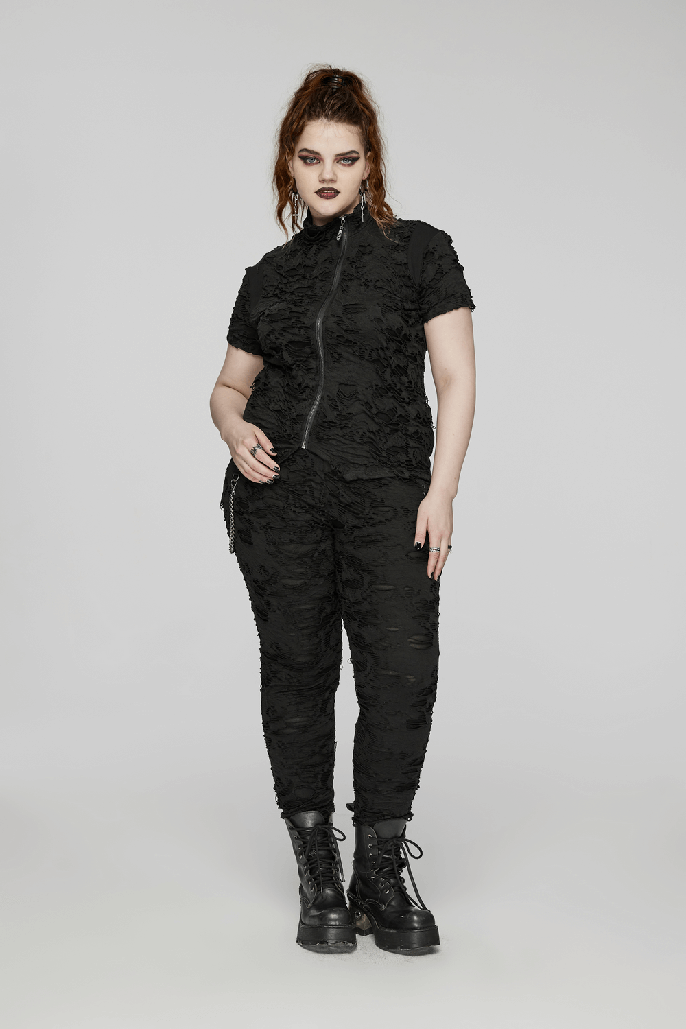 Black tattered punk top with front zipper, paired with matching pants, featuring a rebellious slim fit look.
