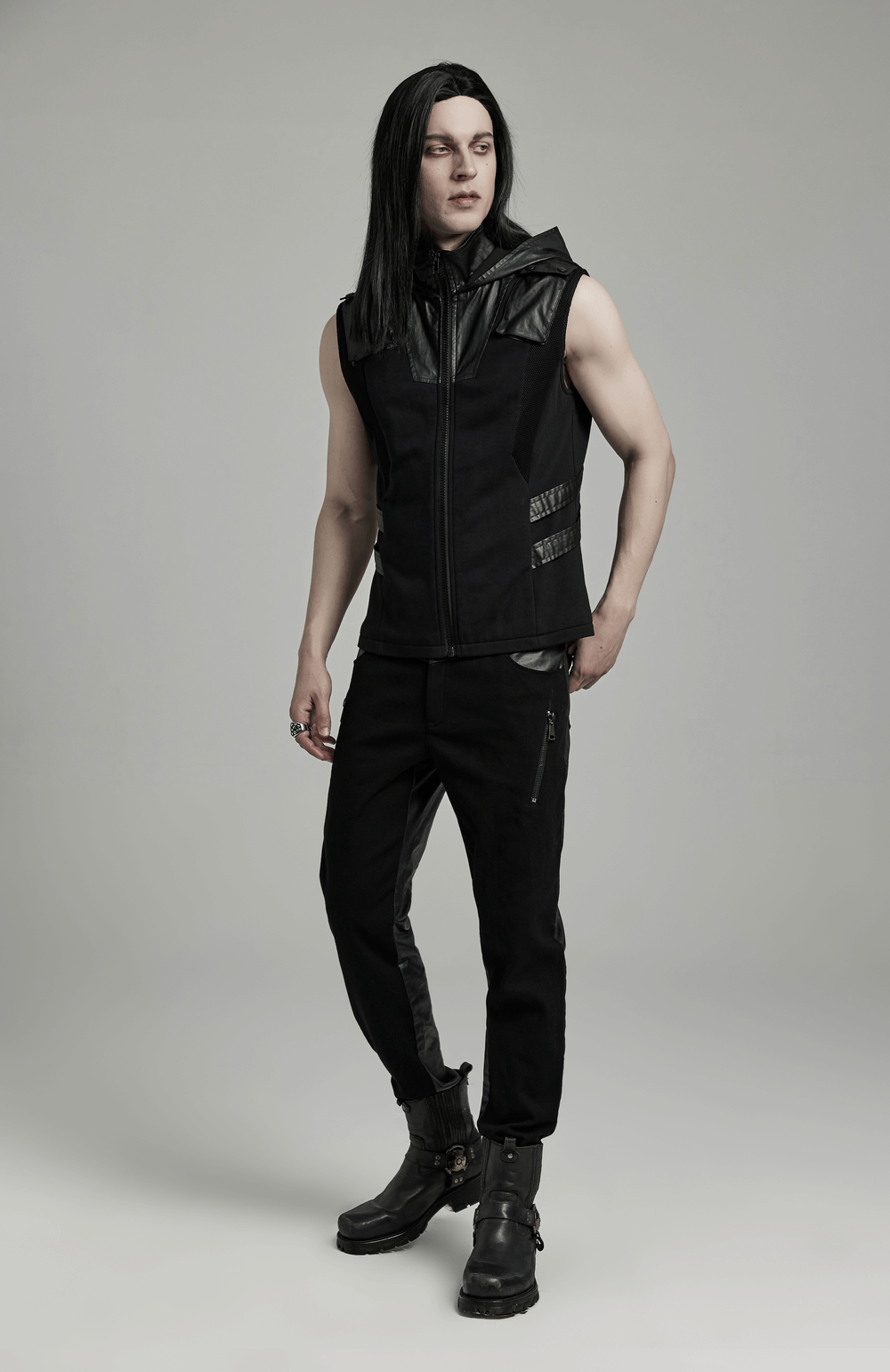 Men's black techwear sleeveless hoodie with leather accents and zipper, showcasing a stylish streetwear look.