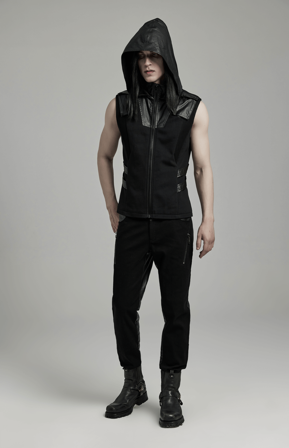 Men's black sleeveless techwear hoodie with leather accents and zipper, embodying stylish streetwear.