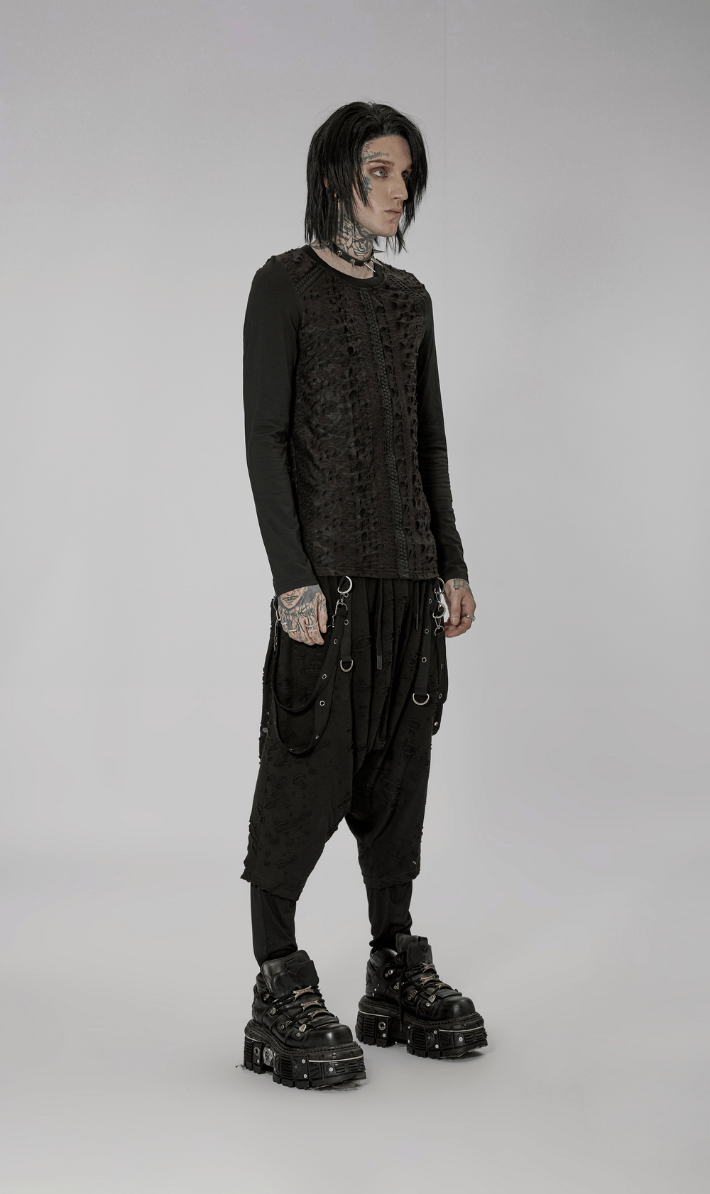 Model showcasing textured webbed gothic long sleeves knit top paired with stylish baggy pants and chunky platform shoes.