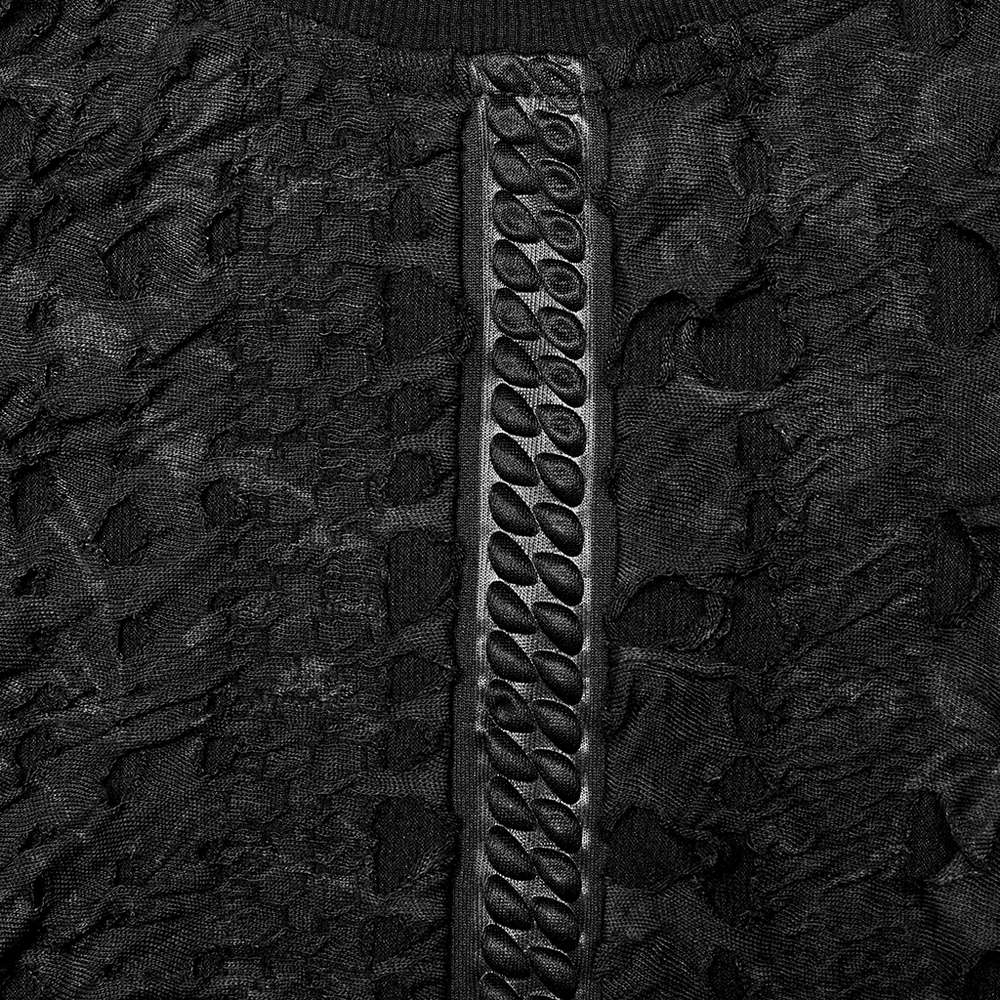 Close-up of textured webbed black knit fabric with unique concave-convex pattern and stylish detailing for a gothic look.