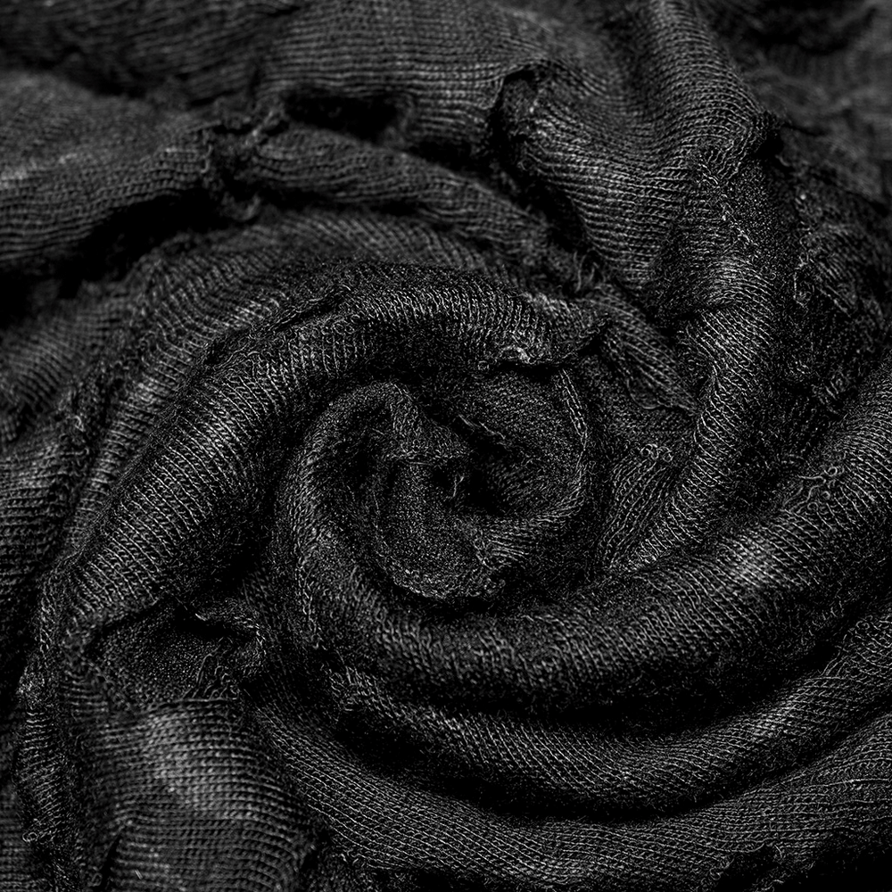 Close-up of textured black fabric in a swirling pattern, perfect for gothic fashion and stylish clothing.