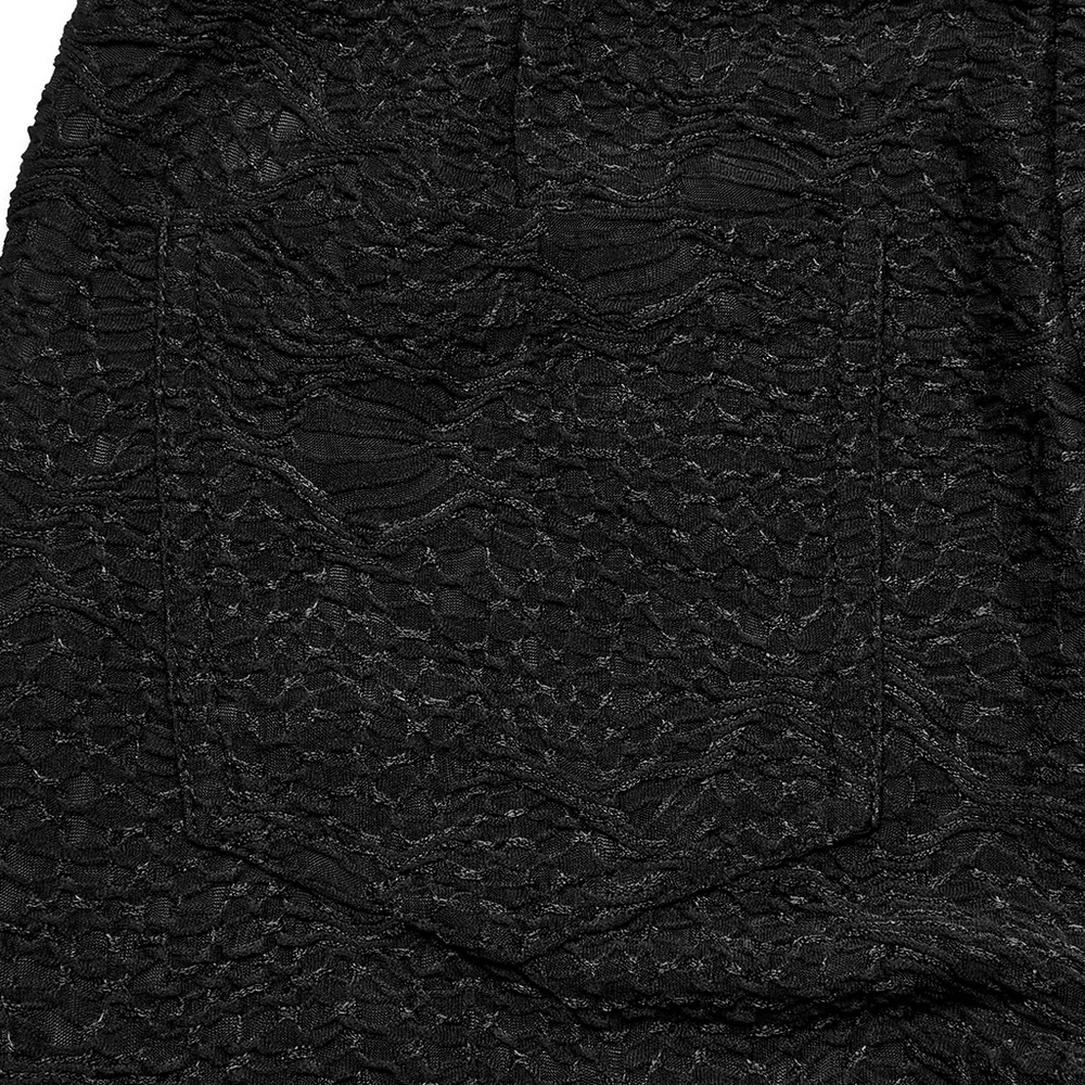 Close-up of Gothic black lace texture on leggings, showcasing intricate patterns and edgy style.