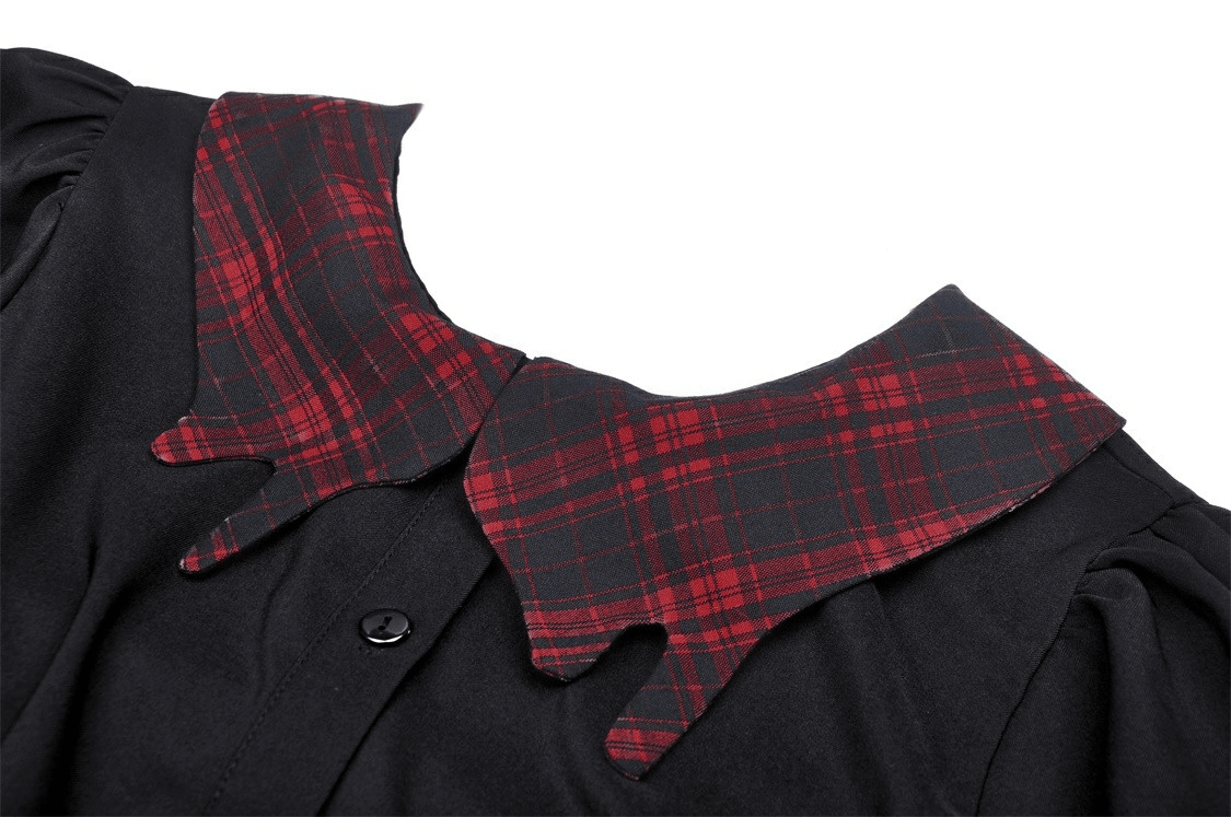 Close-up of trendy black dress featuring a stylish plaid collar and bow detail, perfect for spring and summer fashion.