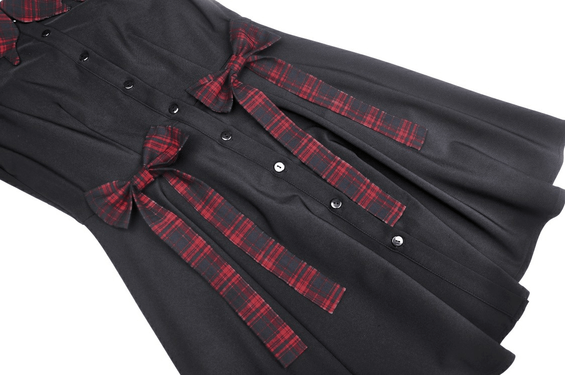 Trendy black A-line dress with plaid accents and bow details, perfect for stylish spring and summer outings.