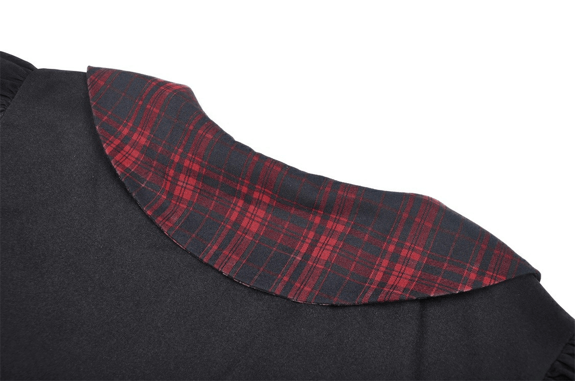Close-up of trendy black dress collar featuring red and black plaid accents, perfect for stylish summer outings.
