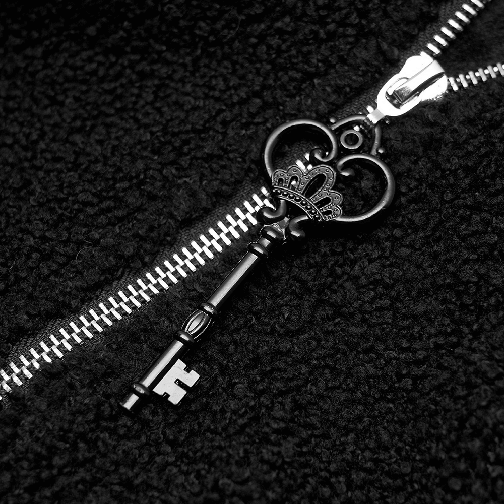 Close-up of a black zippered hoodie featuring a decorative crown key zipper pull.