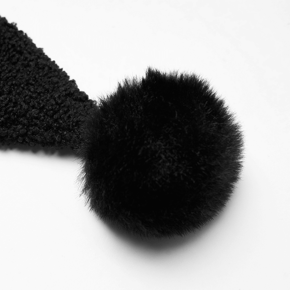 Close-up of a black clown hat hood with a fluffy pom-pom, perfect for a trendy and playful look.
