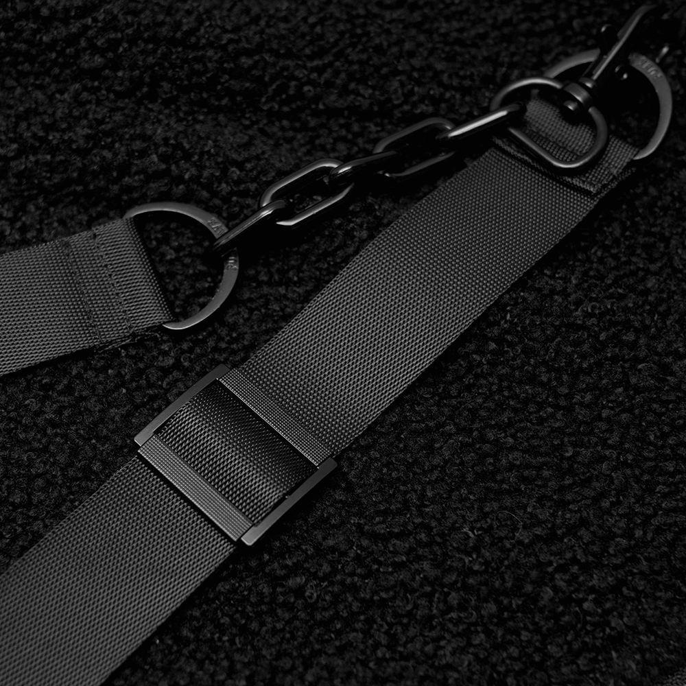 Close-up of black adjustable strap with chain detail, showcasing the edgy design of a trendy black hooded jacket.