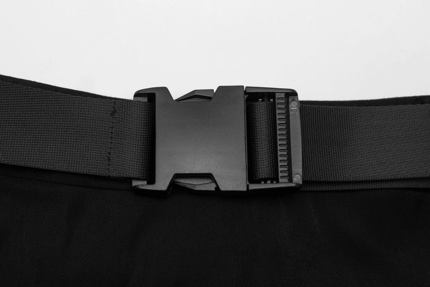 Close-up of a black buckle on a durable belt, perfect for securing edgy streetwear styles.