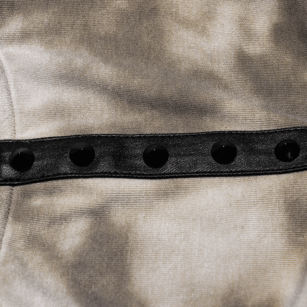 Close-up of the decorative tab and grommets on a trendy tie-dye hooded crop top's fabric.