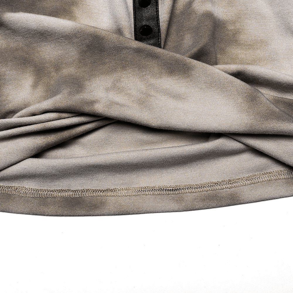 Close-up of trendy tie-dye hooded crop top fabric featuring a button detail and stylish pleat design.