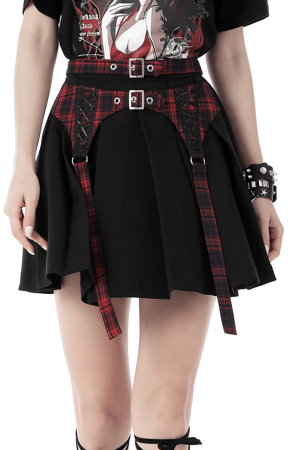 Trendy plaid and black mini skirt with buckles and pleats, perfect for modern fashion enthusiasts.