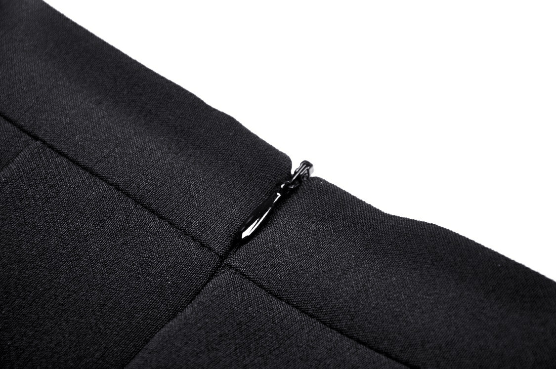 Close-up of the zipper detail on a trendy black mini skirt showcasing stylish craftsmanship.