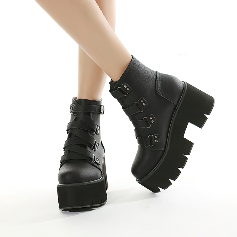 Trendy black leather ankle boots on a platform with buckle detailing, perfect for casual outfits.