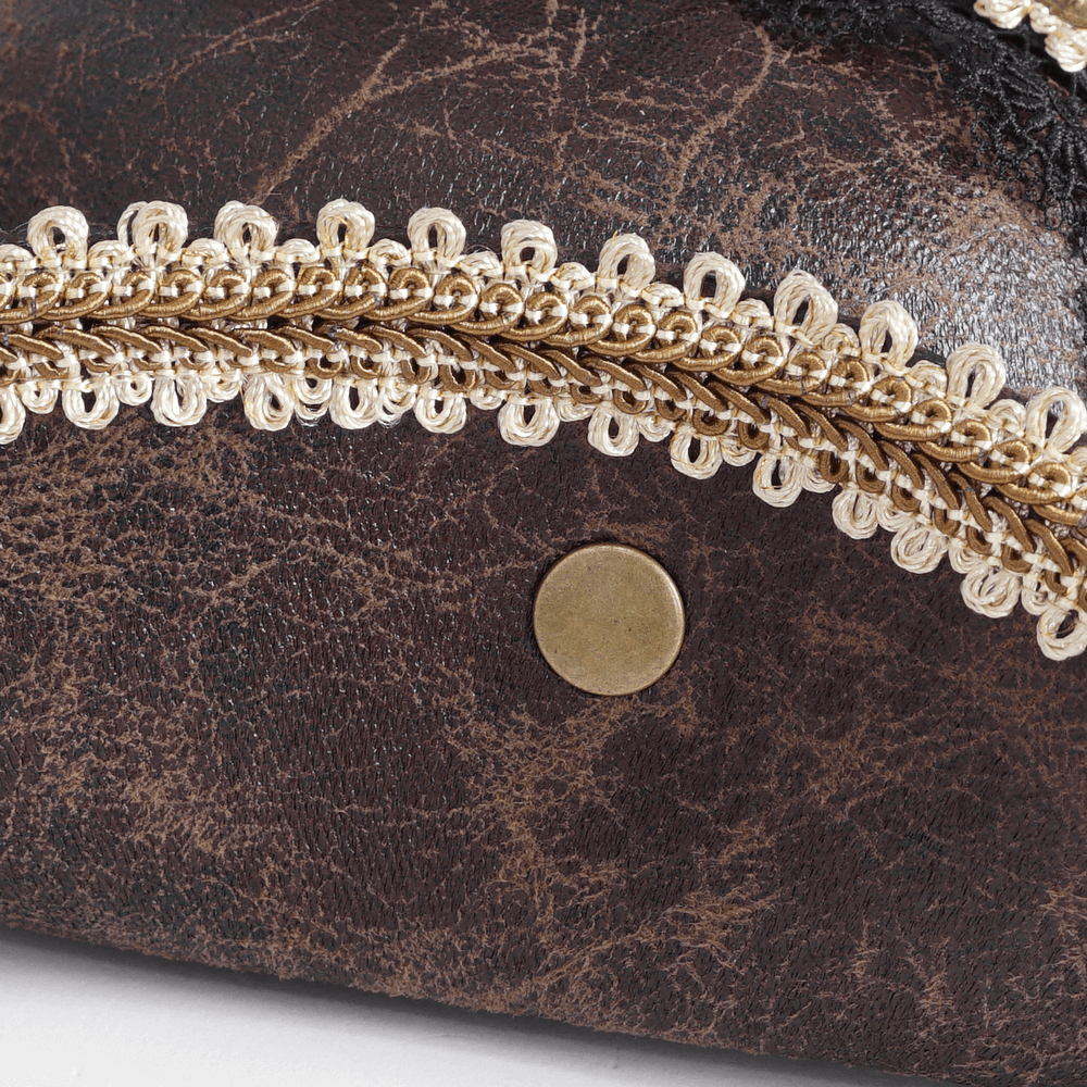 Close-up of a brown leather design featuring intricate gold trim and decorative lace detail.