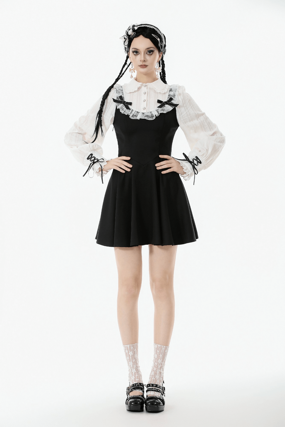 Unique Black and White Dress with Lace Collar and Bows worn by a model with puff sleeves and lace accents.