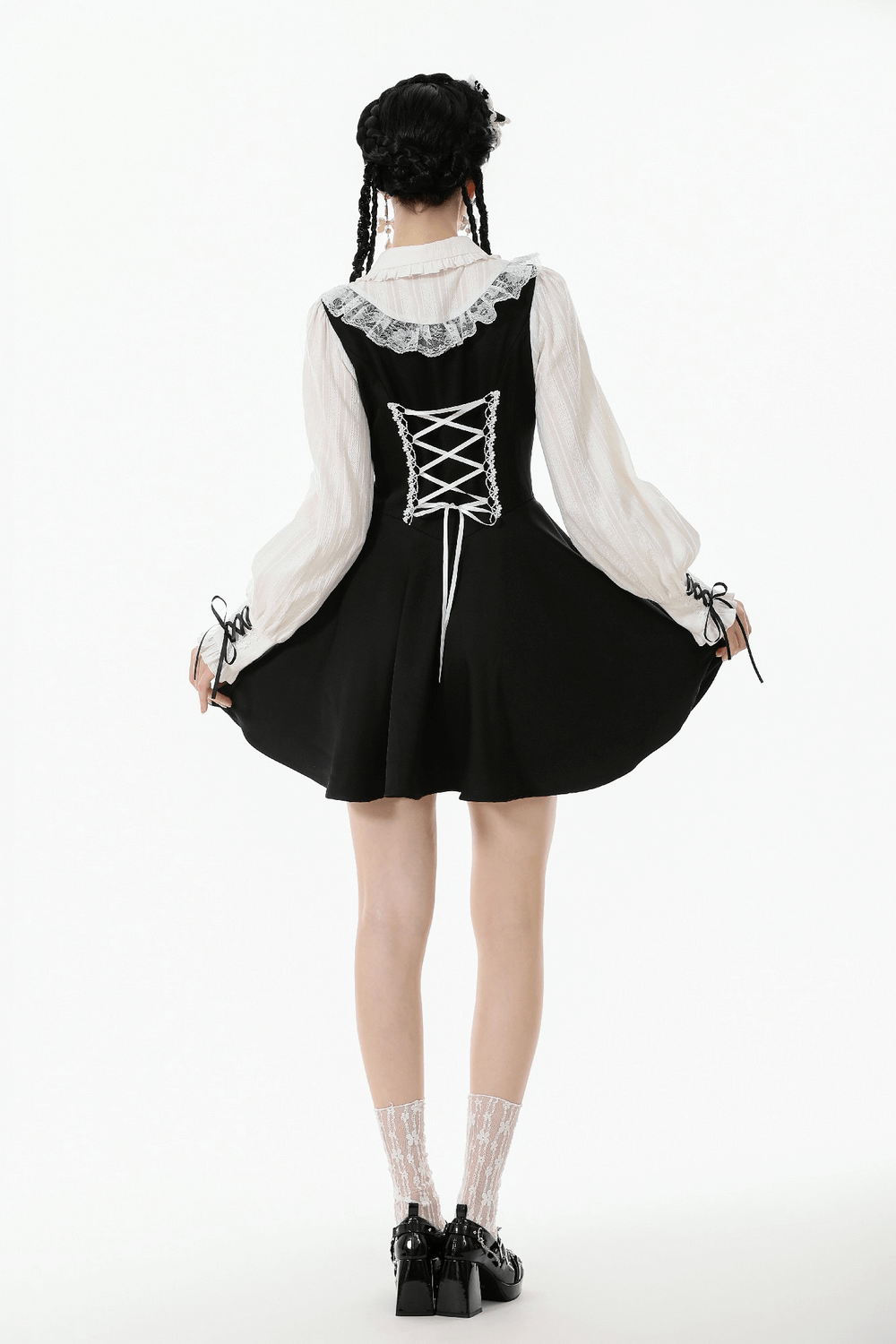 Unique Black and White Dress with Lace Collar and Bows viewed from the back, featuring lace-up details and ruffled accents.