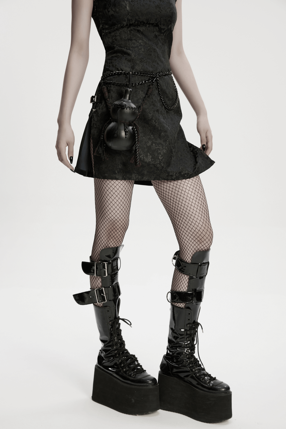 Unique Black Crossbody Mini Bag with Chains and Tassels worn with goth outfit and platform boots.