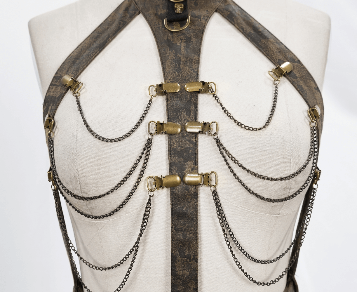 Unique vintage women's brown leather body harness with metal chains and bronze fittings for an elegant look.
