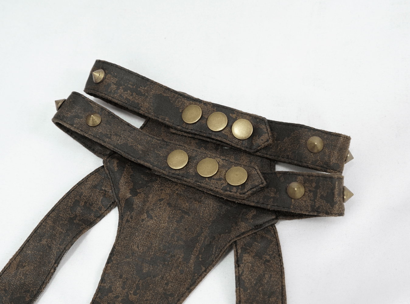 Vintage brown leather body harness with bronze fittings and studs for women, perfect for a gothic or witchy style.