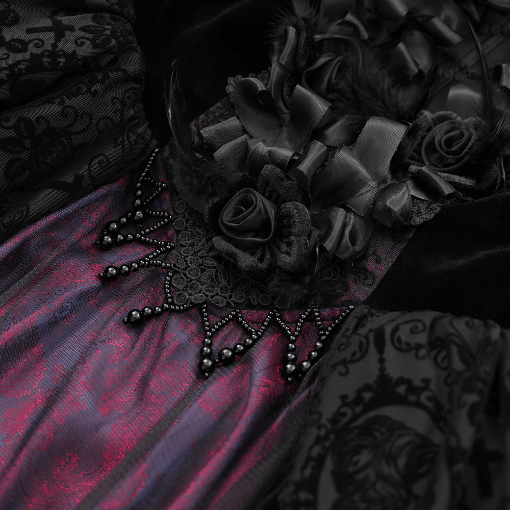 close-up of unique Victorian lace dress with ruffled sleeves, featuring intricate embroidery and dark floral accents.