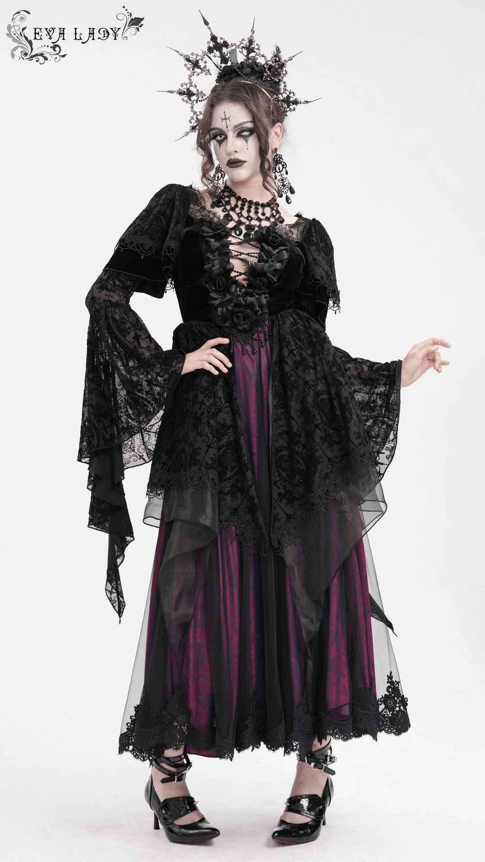 Elegant gothic model in black Victorian lace dress with ruffled sleeves and dramatic layered skirt. Perfect for dark fashion.