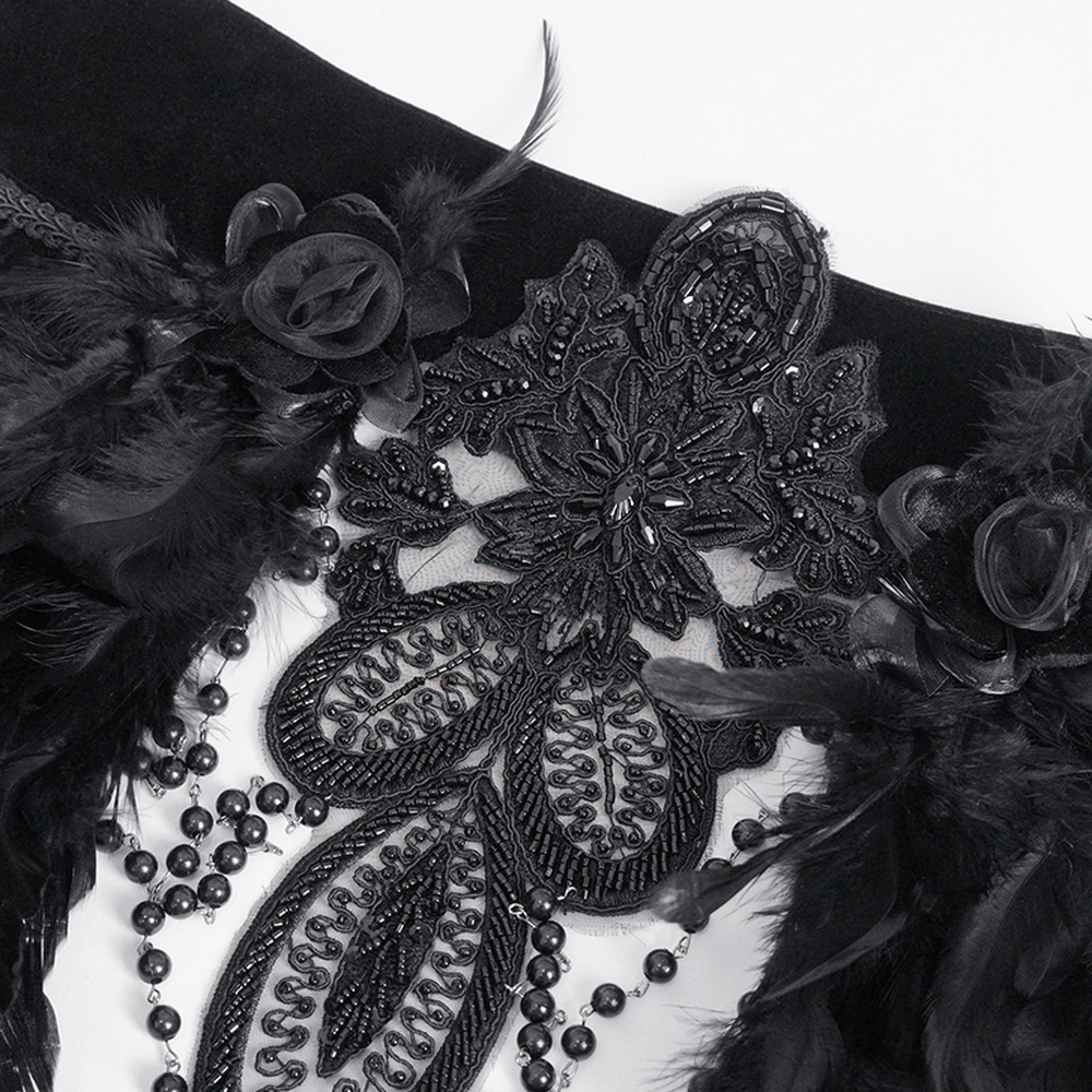 Close-up of a Gothic beaded feather collar with intricate lace, beadwork, and luxurious black feathers.