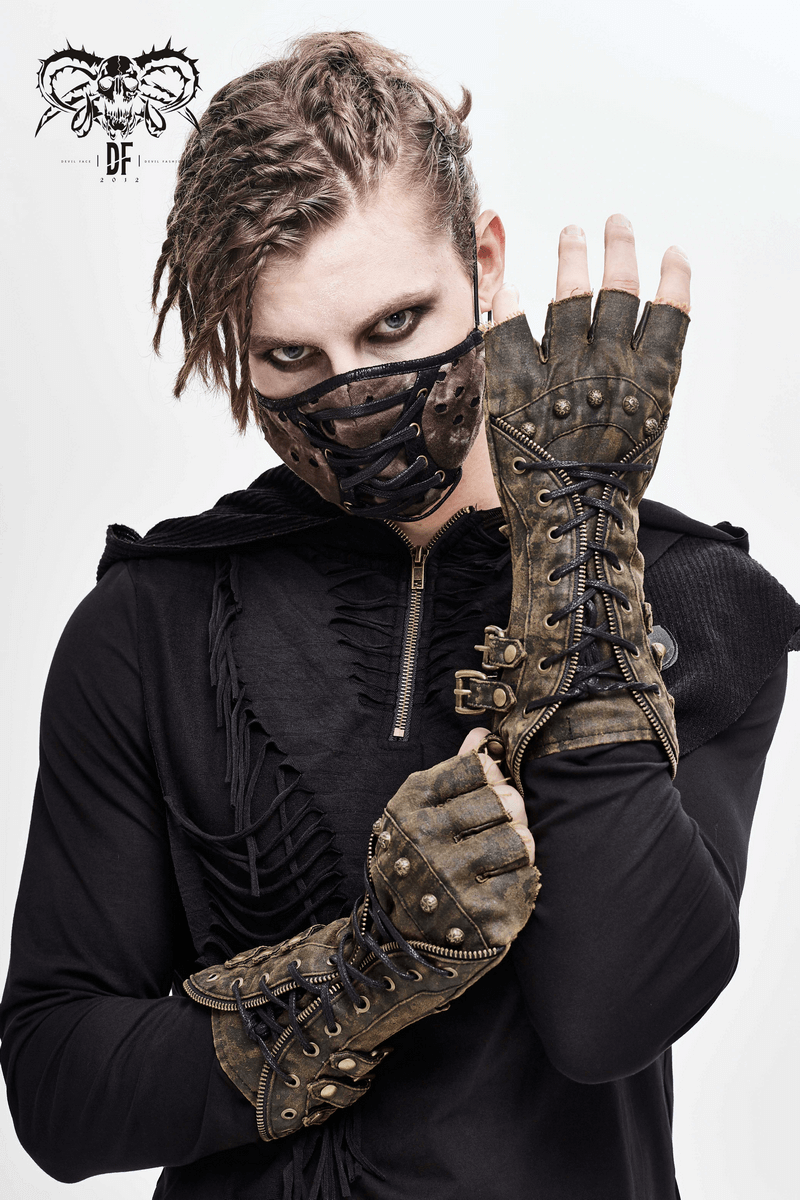 Model wearing unisex steampunk fingerless gauntlet gloves with buckled straps and a matching face mask in vintage brown.