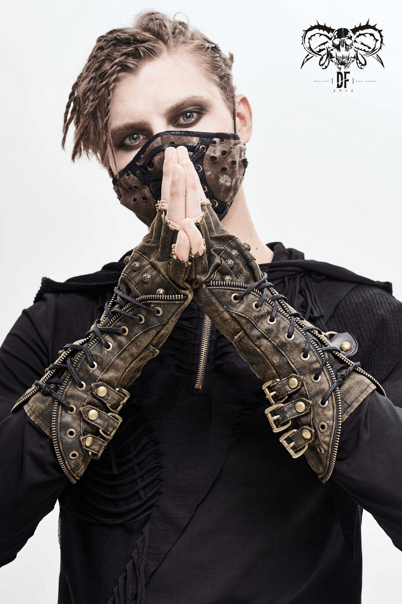 Unisex steampunk fingerless gauntlet gloves in vintage brown with buckled straps, worn by a model.