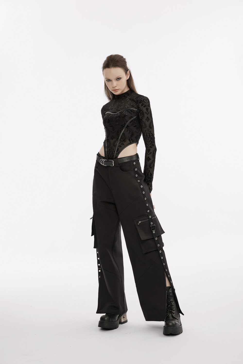 Model showcasing urban black medium waist cargo pants with pockets and a stylish black top.