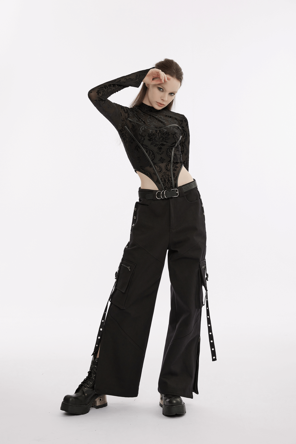 Urban black medium waist cargo pants with pockets, styled with a chic black top and statement boots.